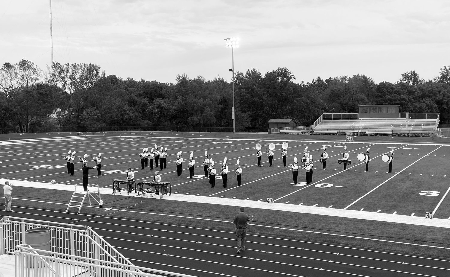 Drum major Olivia Caskey conducts the Mid-Prairie Golden Hawks Marching Band at the 2021 Muskie Marching Invitational.